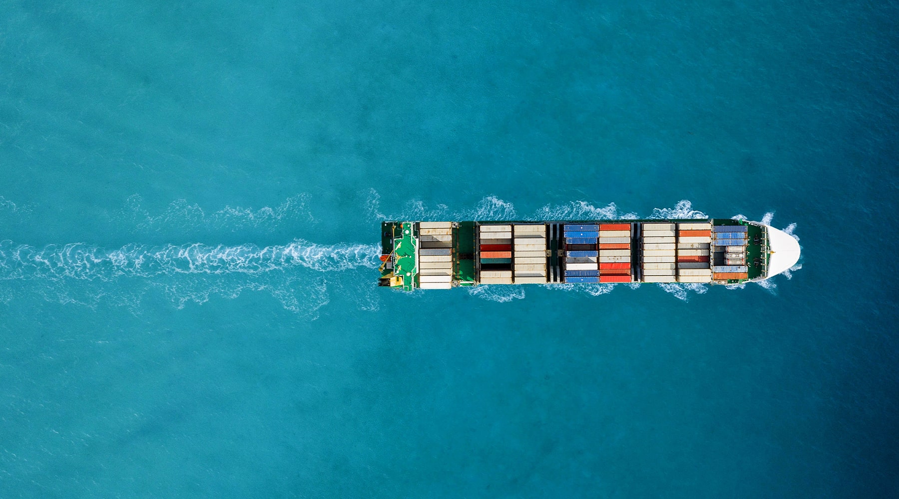 Large ship carrying shipping containers across the sea