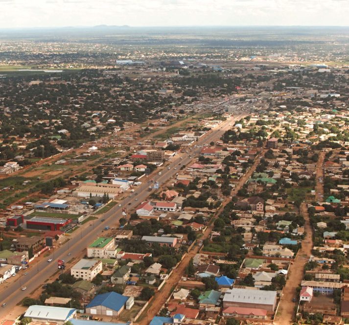 Aerial view of a town, containing buildings and busy roads