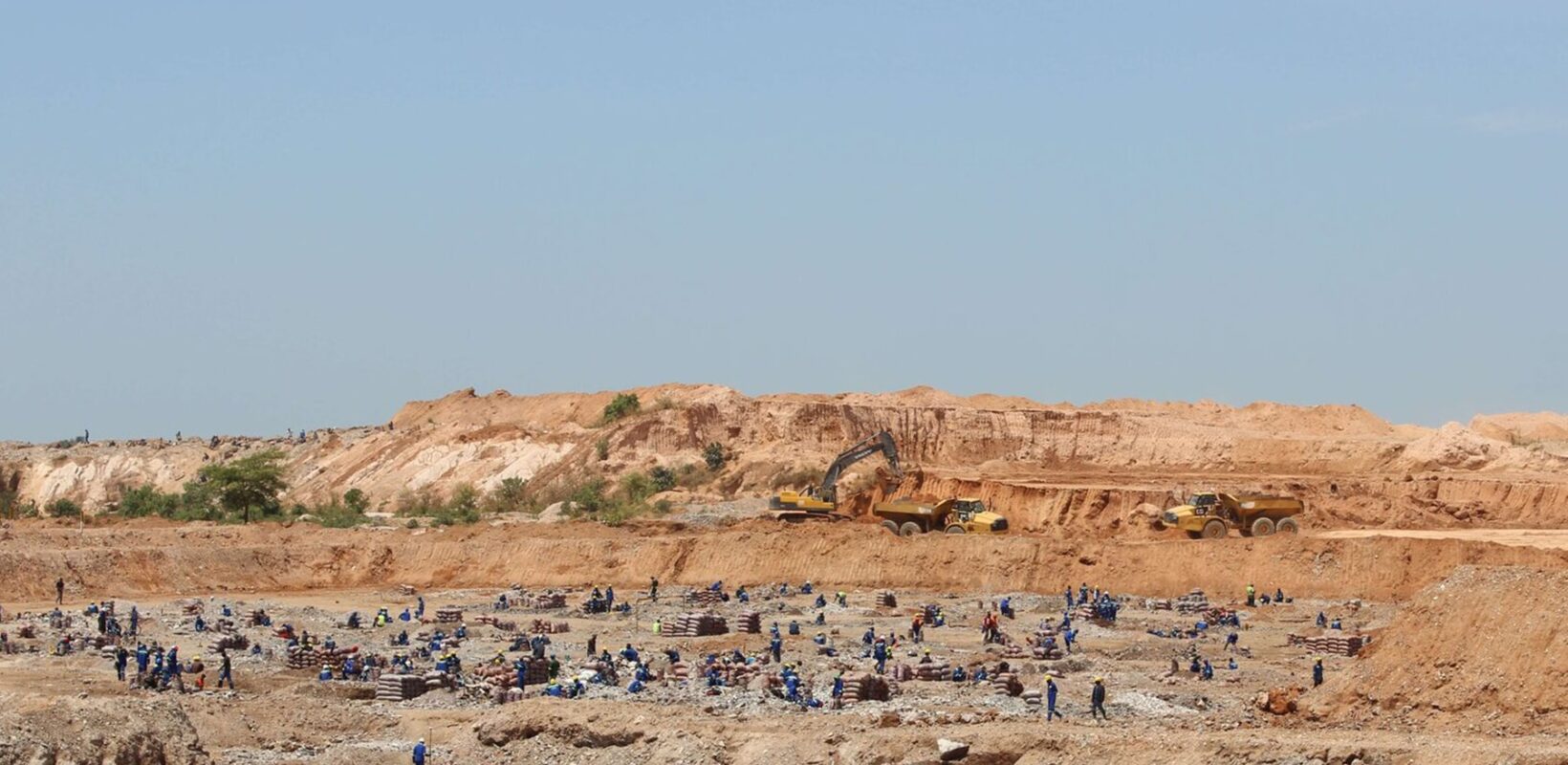 Large mining site, with multiple workers across the landscape