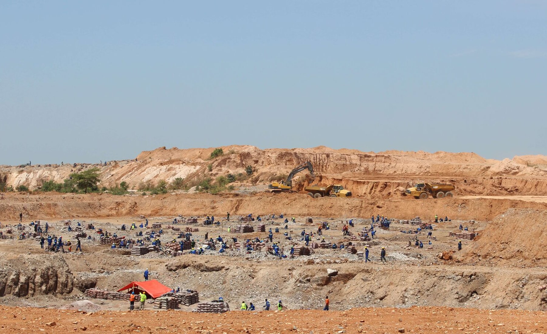 Large mining site, with multiple workers across the landscape