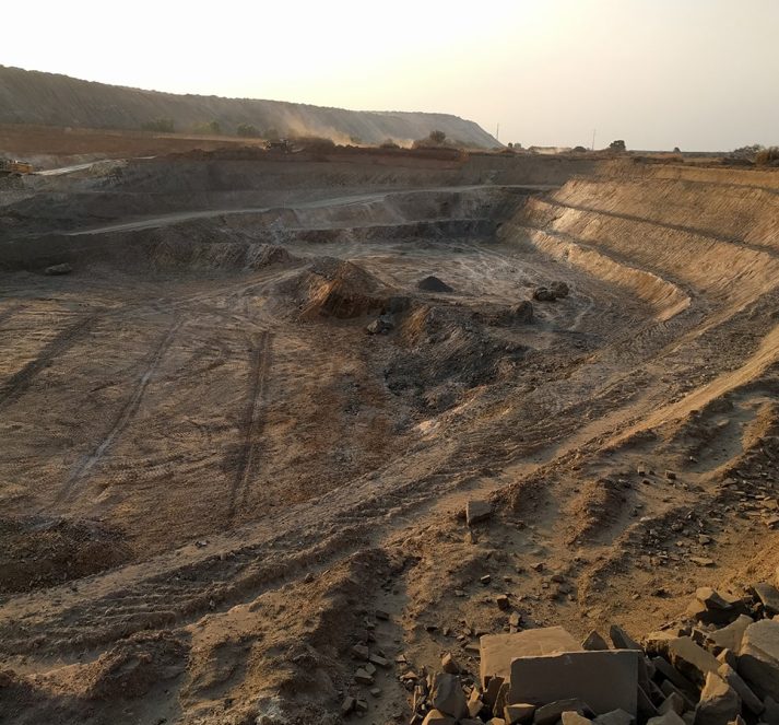 Dusty mining quarry during sunset