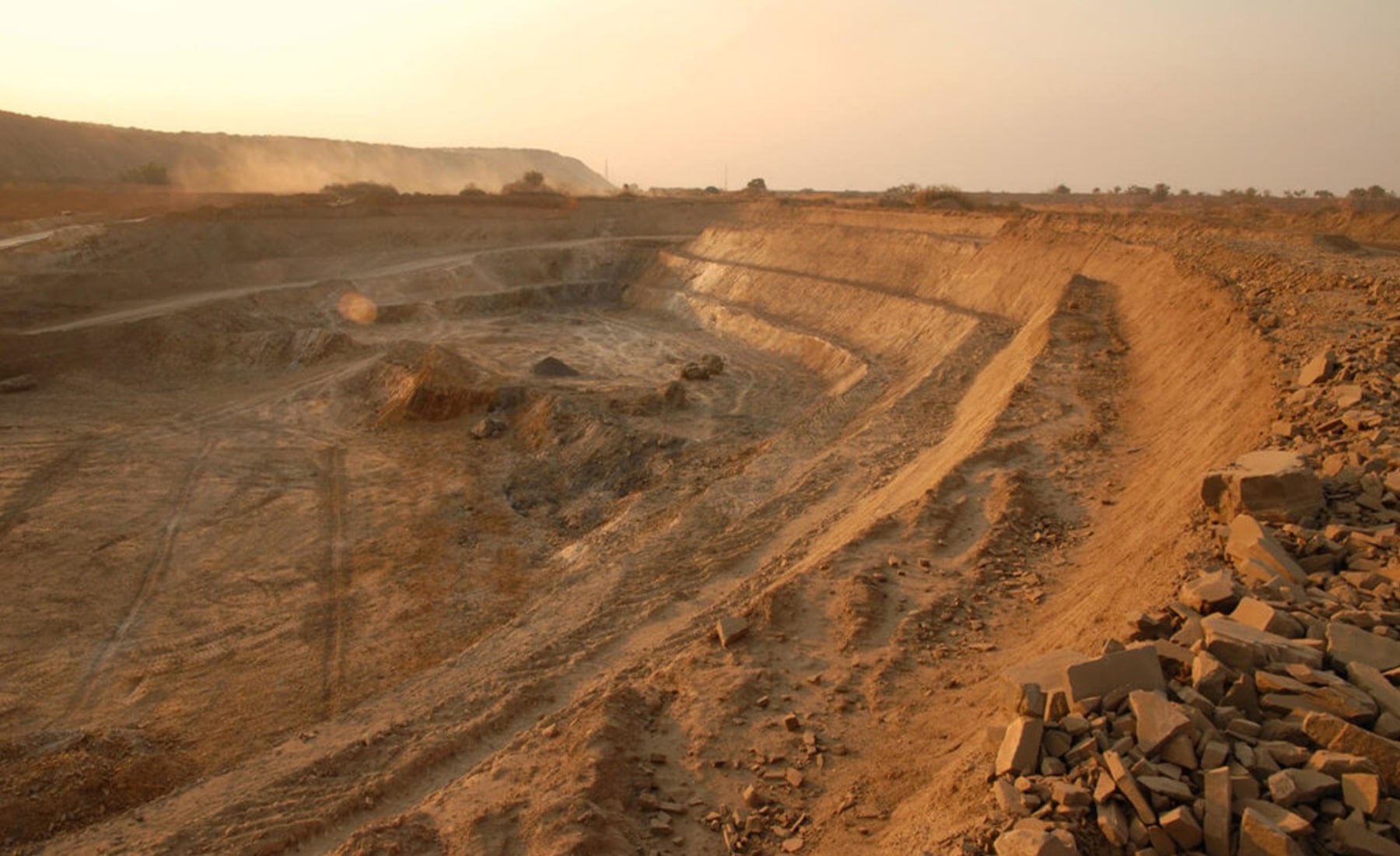 Large mining site, with multiple workers across the landscape