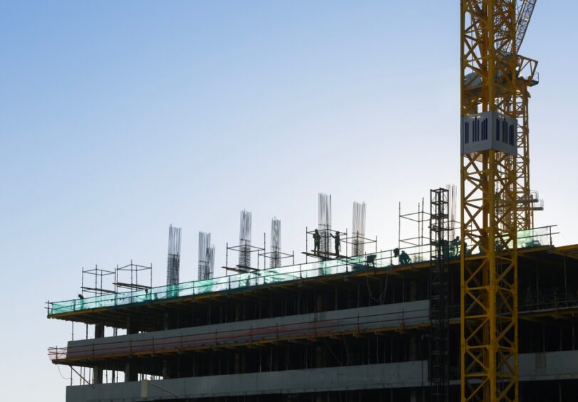 Construction,Site,With,Construction,Workers,During,Work,On,Building,Roof